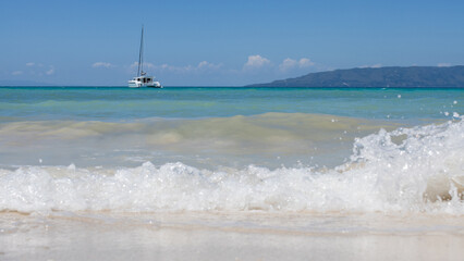 beautiful sea view, with turquoise water and clear, blue sky, a lonely yacht in the sea