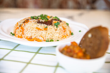 pilaf and salad, black bread on the table