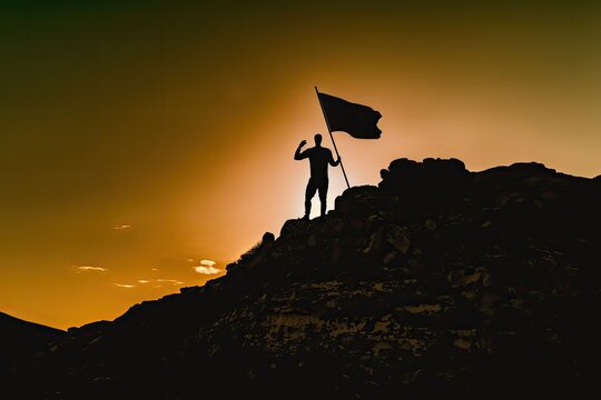 Silhouette of a businessman stands triumphantly on a mountain top, holding a flag against the backdrop of a bright sky and sun, powerful and inspiring image created with generative ai technology