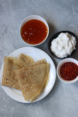 Tiny pancakes on a plate. Delicious crepes with sour filling. Close up photo of tasty meal. Still life with caviar. Healthy eating concept.  