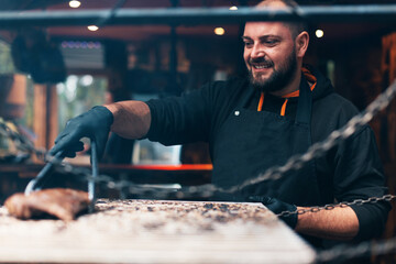 Caucasian male professional chef at a steakhouse preparing grilled ribs