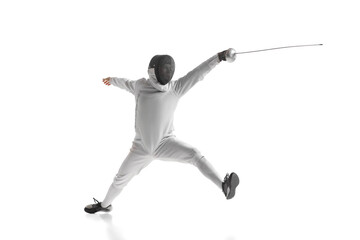 Professional male fencer in fencing costume training with sword isolated on white studio...