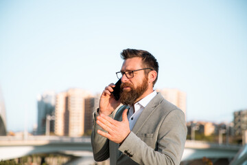 handsome businessman with phone in the city