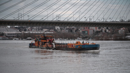 Fototapeta premium A river barge sailing along the river upstream
