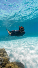 young man snorkeling in the great barrier reef