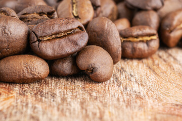 Close up of coffee beans on wooden background. Fresh coffee beans, macro shot