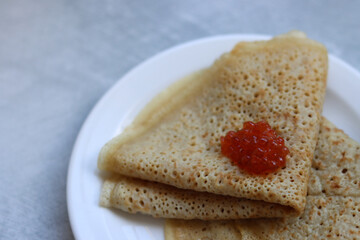 Shrove Tuesday celebration. Tiny Crepes on a plate. Festive food close up photo. 