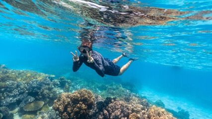 young man snorkeling in the great barrier reef © Juanmarcos