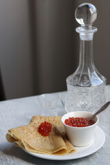 Crepes, caviar and vodka on a table. Food still life photo. Minimalistic composition still life with sour meal. 