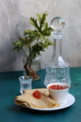 Tiny pancakes on a plate. Delicious crepes with sour filling. Close up photo of tasty meal. Still life with caviar. Healthy eating concept.  