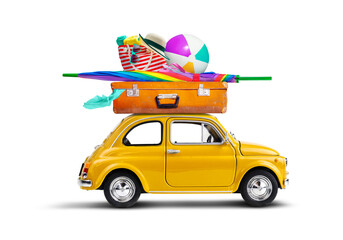 Retro yellow car with luggage and beach equipment on the roof. Summertime vacation road trip concept. - 579678276