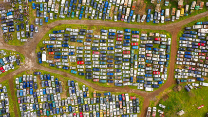 Aerial view of a junkyard. Large parking lot of old, broken and demolished cars.