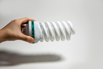 energy saving light bulb spiral in hand on white background isolated