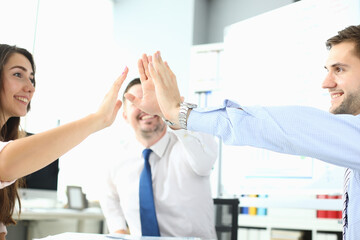 Happy business team high five in office