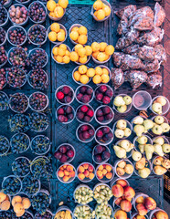 Tubs of fresh fruit such as grapes, pears, plums, peaches and bananas sold on the streets of Cape...