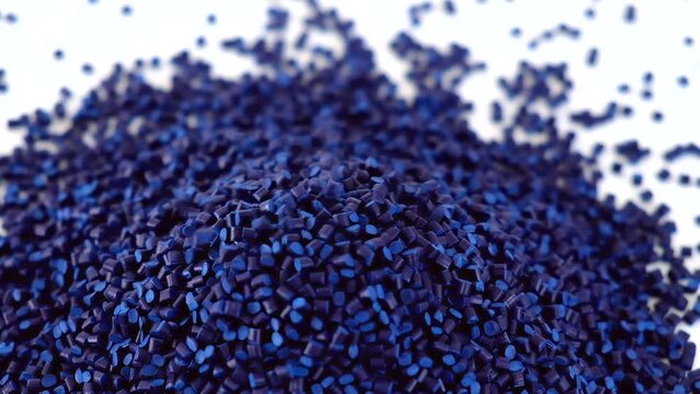 Blue raw plastic granules for industry on a white background