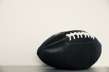 Rugby ball with white background. American soccer sport. Ball with space for text. Black and white.