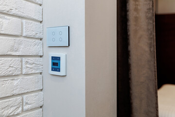 Air conditioner screen on the wall. a device for controlling underfloor heating. Sensor switch of light