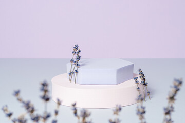 Beautiful podium for product presentation with lavender flowers on violet background. Showcase for branding, gift, cosmetic and perfume presentation, spring concept