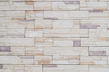 Cream stonewall with hirizontal pattern used for background texture in decorative art work