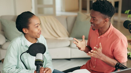 Interview, podcast and radio show with young influencer man and woman talking and having a...