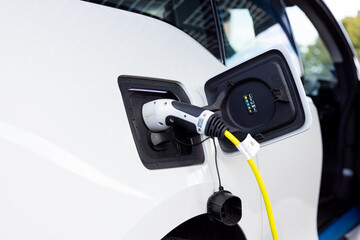 Gateshead UK: 26th Sept 2021: A hand-held closeup of an electric car on charge (EV, green...