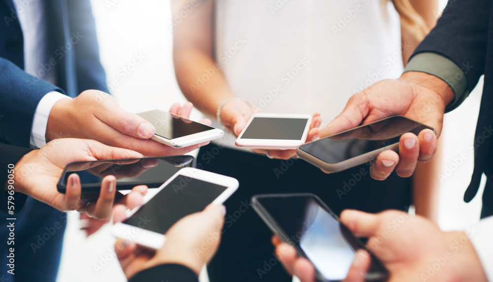 Sticker The smart platform for connecting with professional peers. Cropped shot of a group of businesspeople standing in a circle and using their smartphones in a modern office.