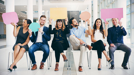 Im the ideal candidate because...Shot of a group of businesspeople holding colorful speech bubbles...