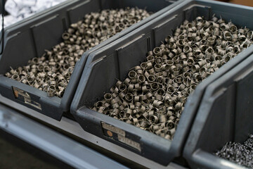 Crate of Metal Coils set in foreground of Factory Setting with array of Work Benches and...