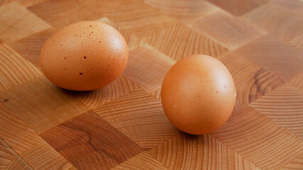 two eggs on a wooden board