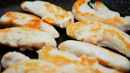 chicken meat is fried in a frying pan