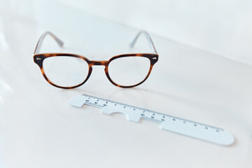 Clarity comes in pairs. Shot of a pair of glasses and a pd ruler in an optometrists office.