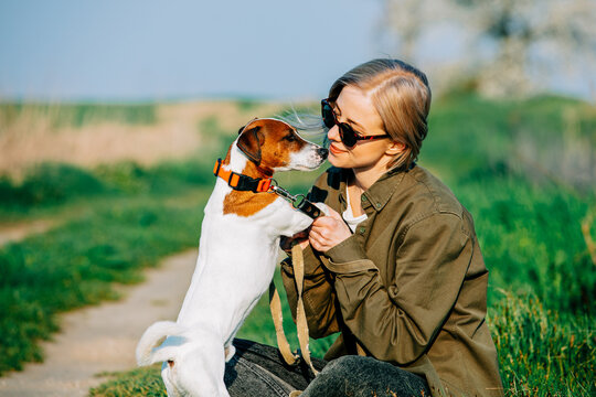 Blonde with jack russell terrier dog on country road