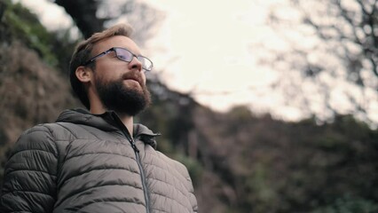 Bearded travel man in eyeglasses relaxing contemplating nature landscape dreaming enjoy calmness
