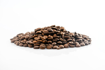 A pile of roasted coffee beans on a white background.