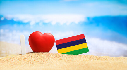 I love Mauritius. Flag of Mauritius on the beach with a red heart. vacation and travel concept.