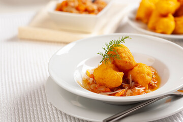 cod fritters with tomato and onion sauce