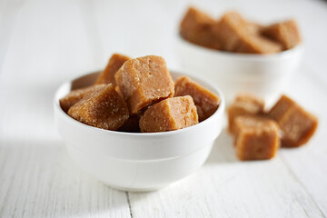 Close up brown cane sugar on white background