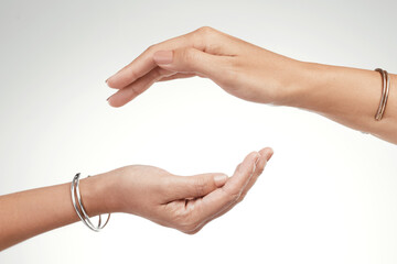 Support is a give and take. Cropped shot of two unrecognizable women posing with their hands cupped above each other.