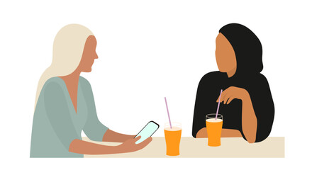Portrait of two young women talking at table. The concept of friendship or business between people of different cultures.