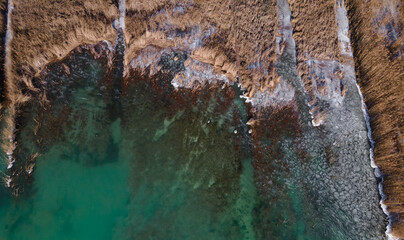 Aerial view of the lake, Balaton in Hungary. Green iced lake in winter. Drone view.