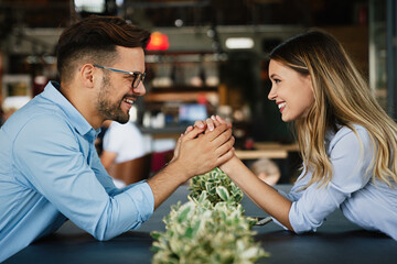 Romantic loving couple drinking coffee, having a date in the cafe.