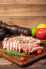 Fresh raw lamb spare ribs. Uncooked sliced lamb ribs on a wood serving board