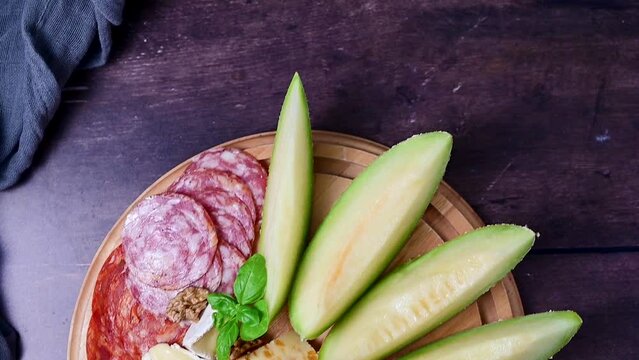 Charcuterie gourmet antipasti plater cheese, salami, prosciutto, melon board. Top view