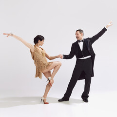 Passion. Elegant couple of dancers in vintage evening dress and suit dancing retro ballroom dance....