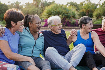 Fototapeta premium Multiracial senior friends having fun together at park after yoga exercise class