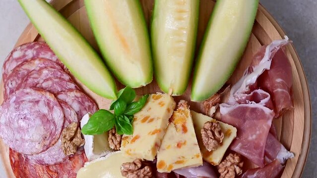 Charcuterie gourmet antipasti plater cheese, salami, prosciutto, melon board. 