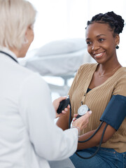 Blood pressure, doctor and black woman patient smile in hospital for healthcare consulting...