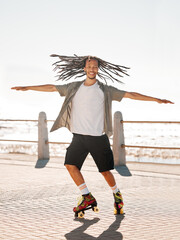 Training, sports and skate with a man roller skating on the promenade by the beach with the sea in the background. Fitness, fun and freedom with a young male on roller skates outside in summer © D Lahoud/peopleimages.com