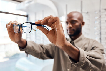 Zoom in on the things that matter. Shot of a young woman buying a new pair of glasses at an optometrist store.